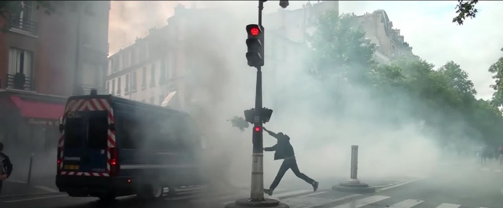 A protester launches a flower pot on a trunk