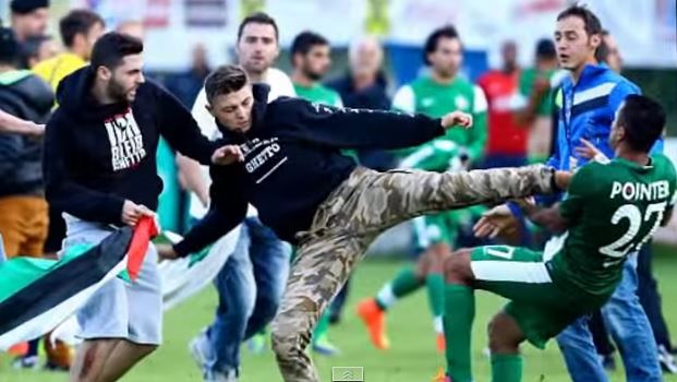 A pro-Palestinian protester attacks a Maccabi Haifa player