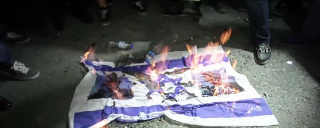 Turkish protesters burn an Israeli flag