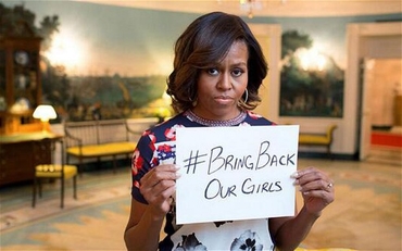 michelle obama holding sign