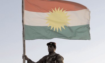 Kurdish soldier holding flag