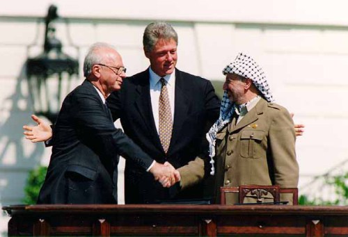 Rabin and Arafat shake hands with former President Bill Clinton at the White House, 1993